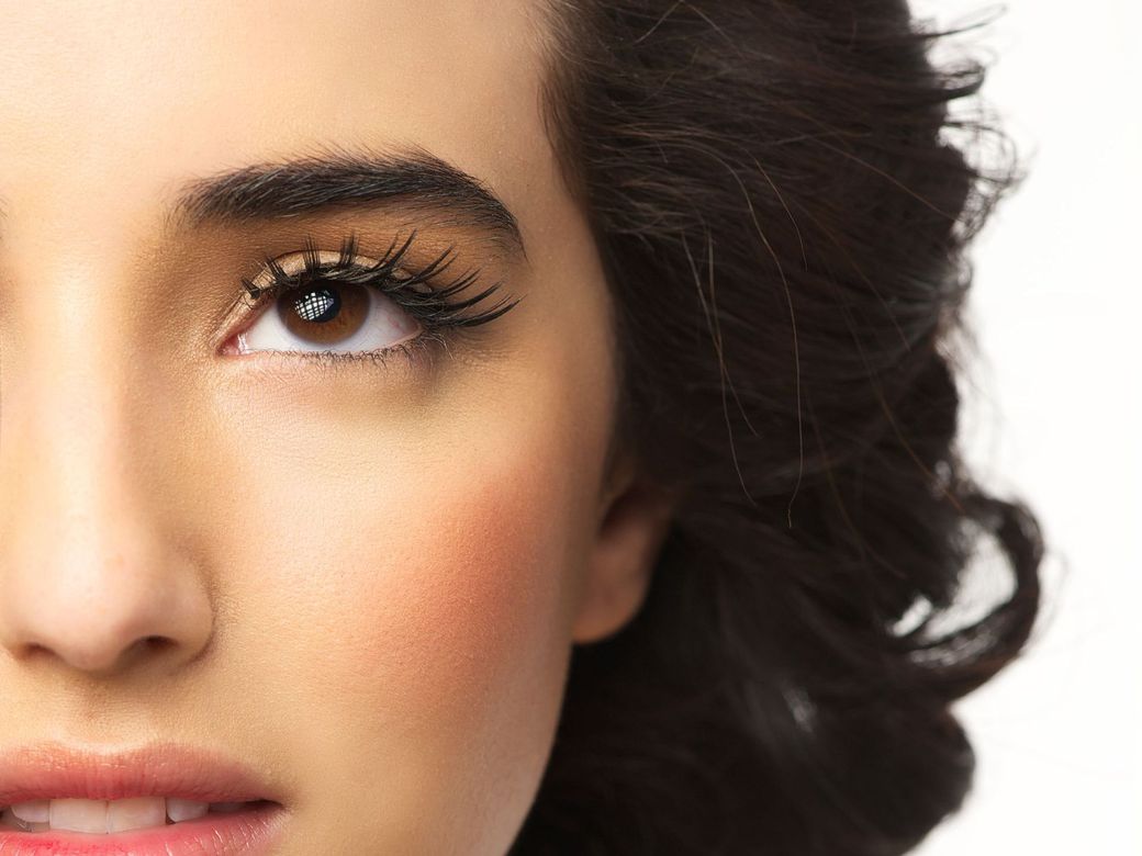 a close up of a woman 's face with makeup on .