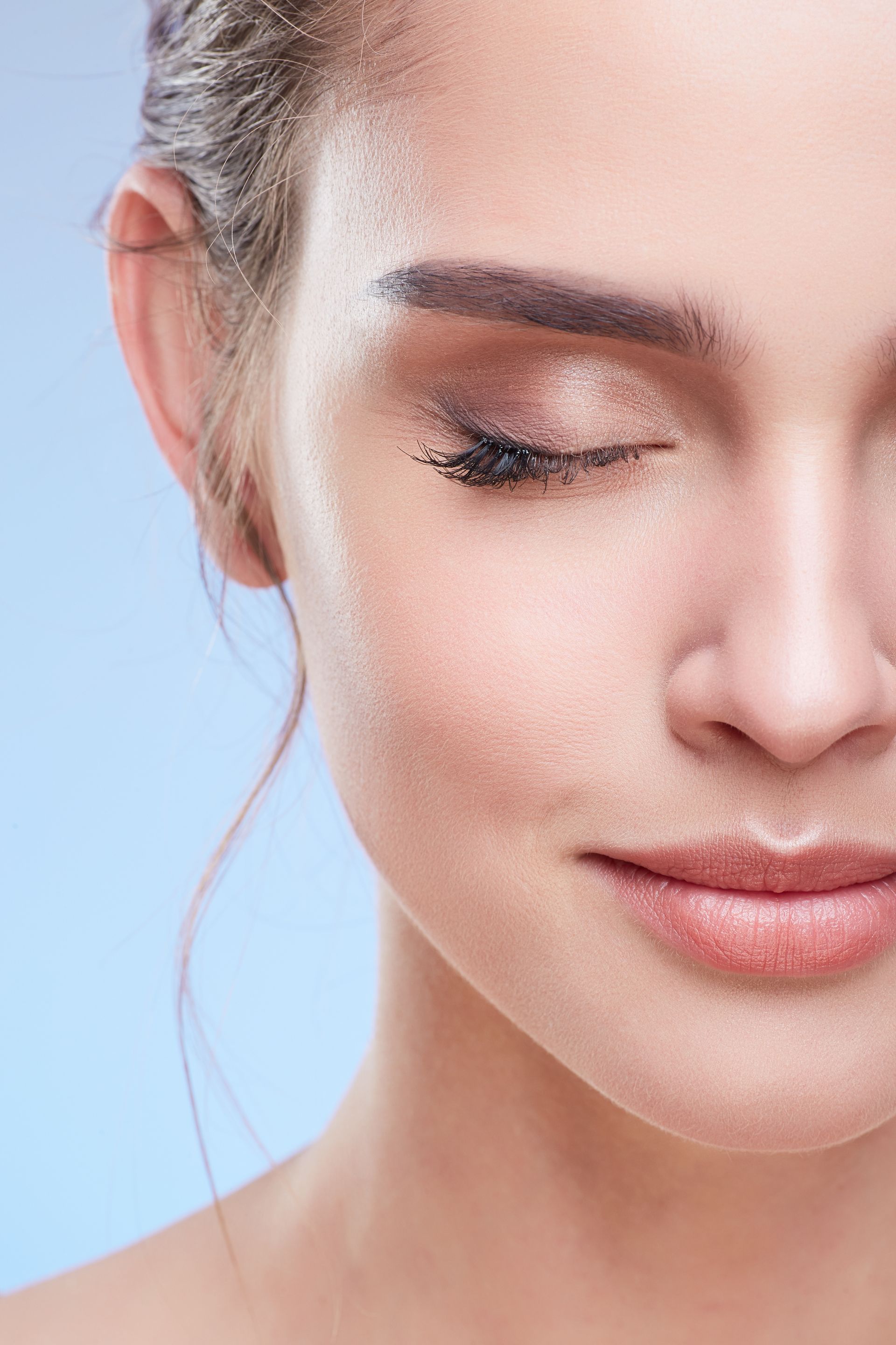 a close up of a woman 's face with her eyes closed .