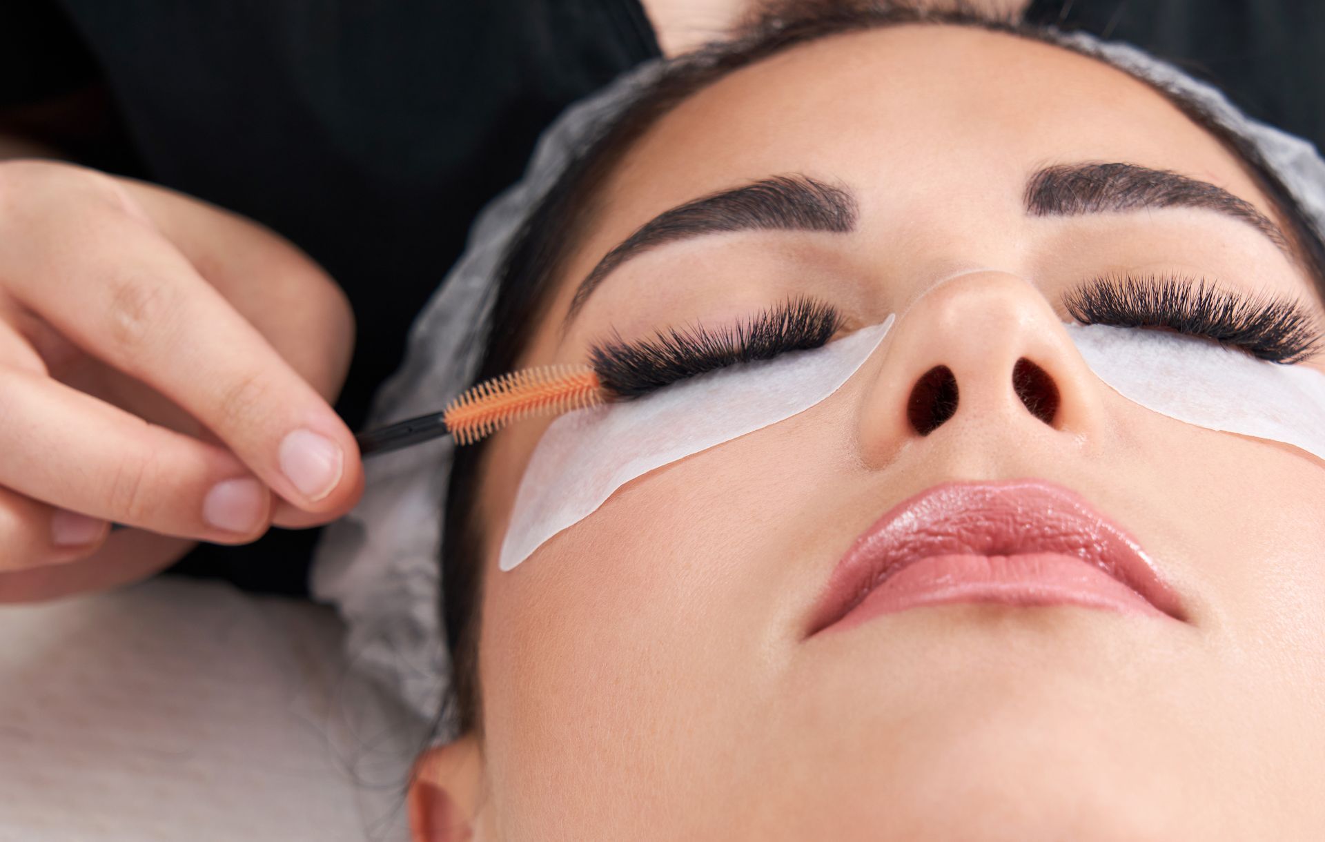 a woman is getting her eyelashes done at a beauty salon .