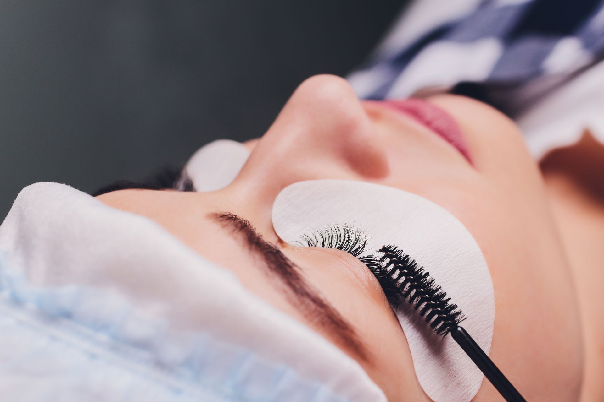 a woman is getting her eyelashes done at a beauty salon .