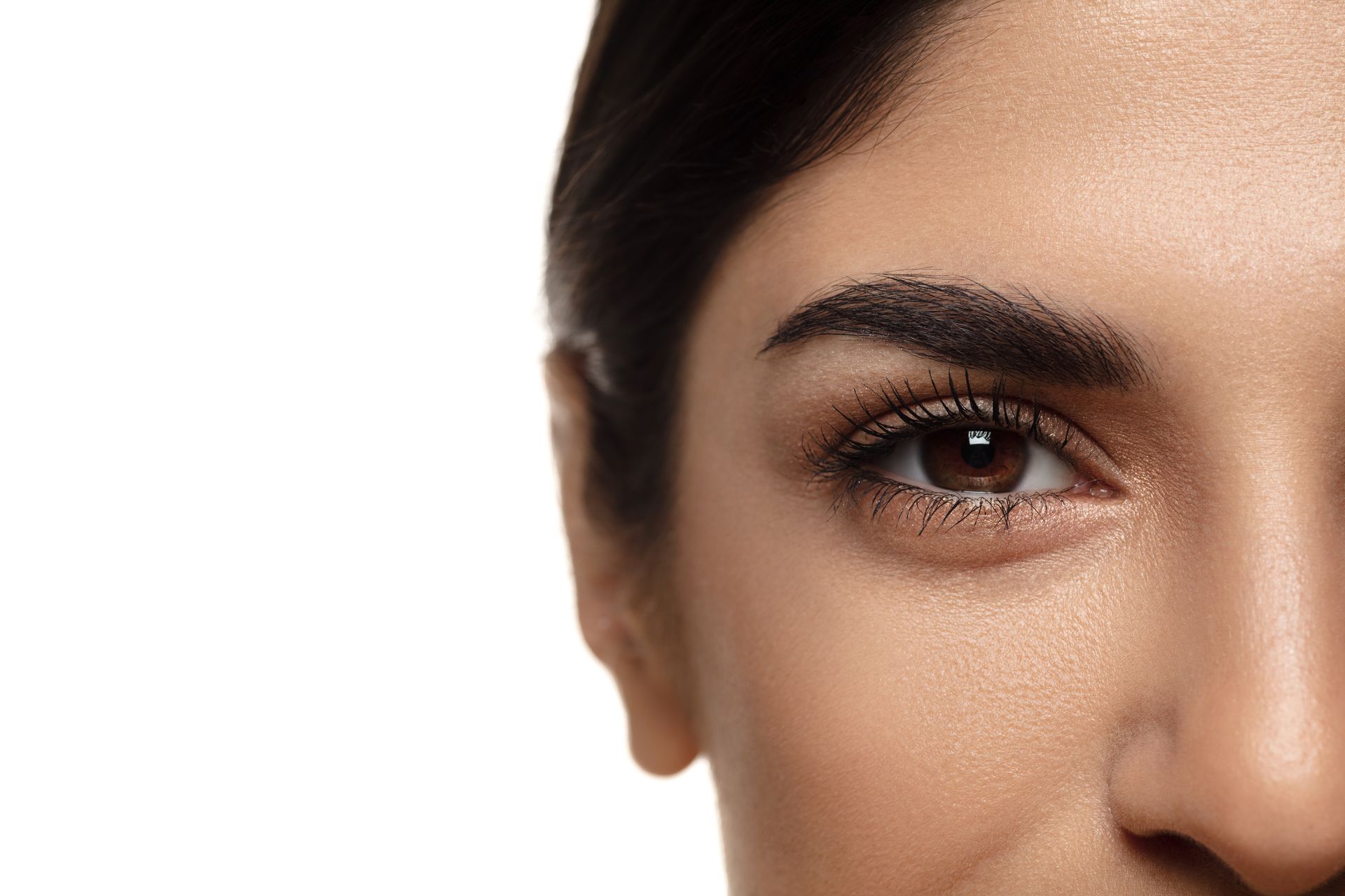 a close up of a woman 's eye and nose on a white background .