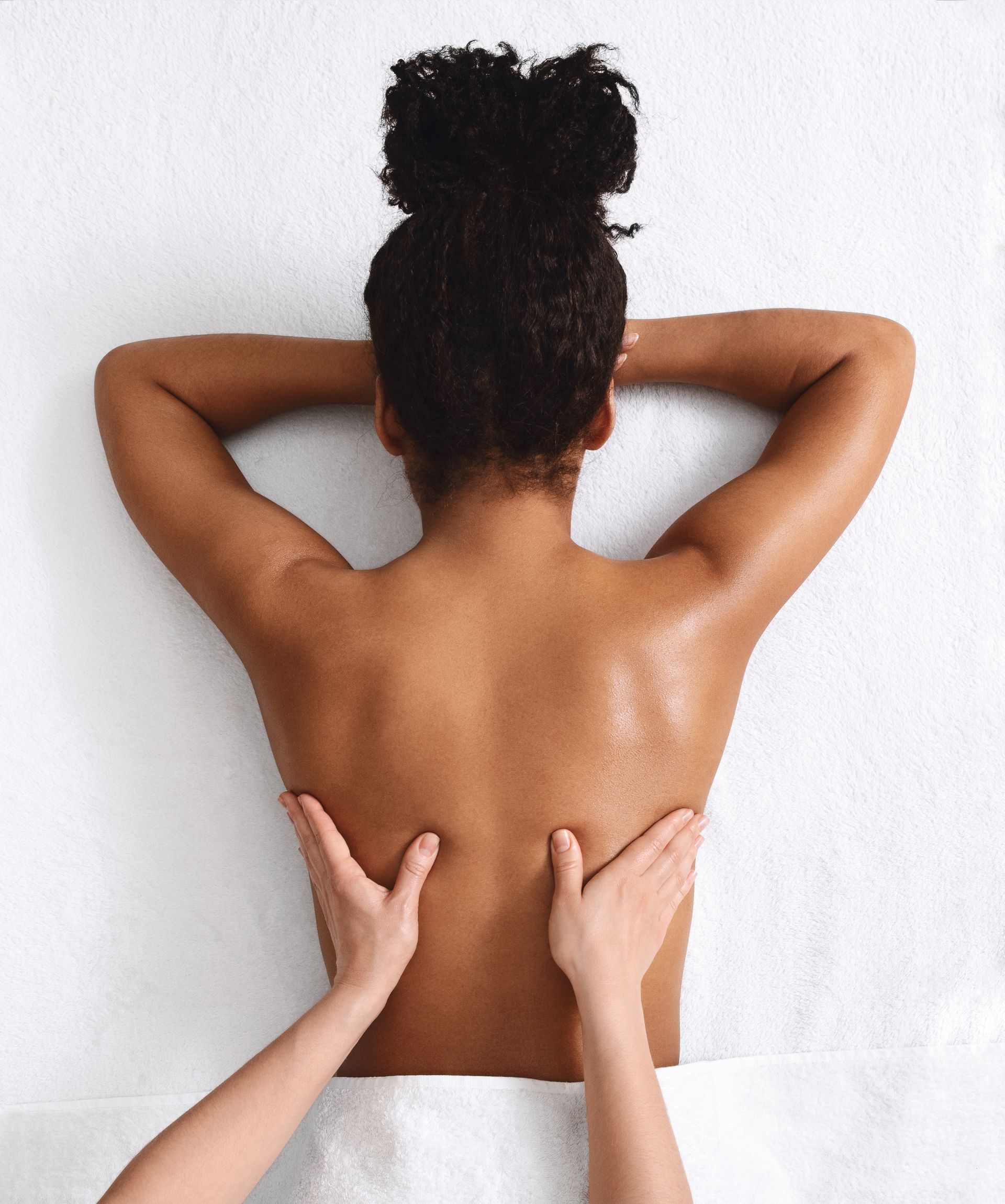 A woman is getting a massage on her back