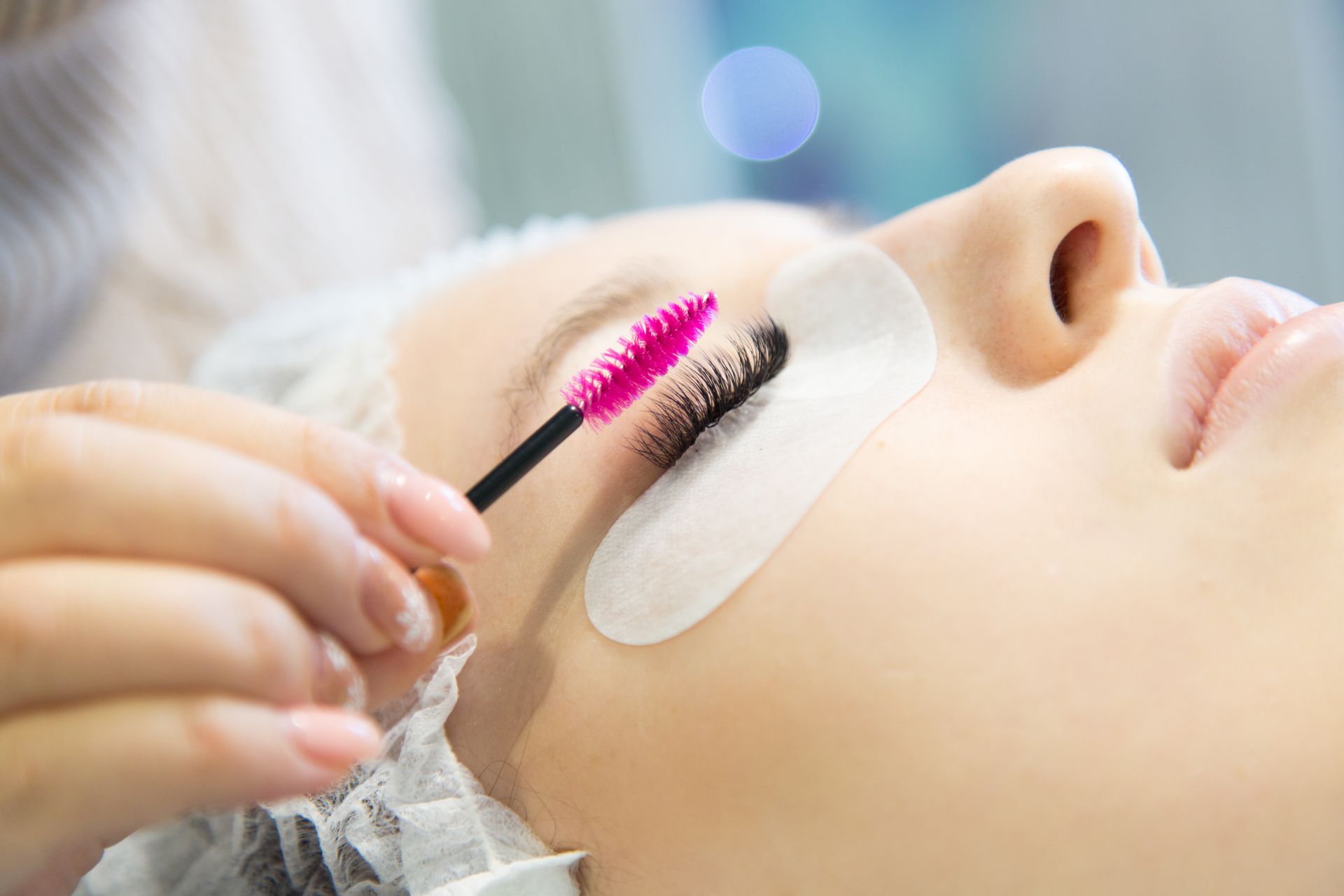 a woman is getting her makeup done by a makeup artist .