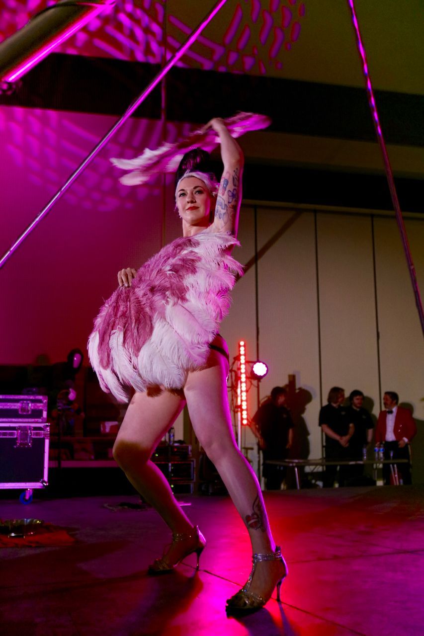Pink and White Feather Fans Photo of Mia Meow with pink / purple lighting on stage by Amy Shipway