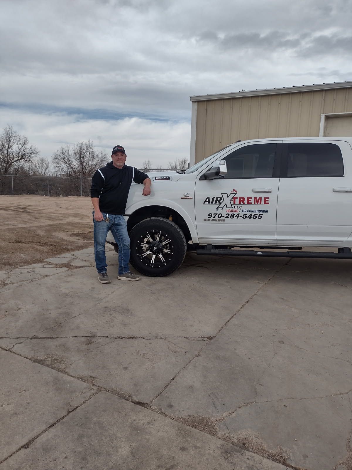 Man in front of a white truck with 