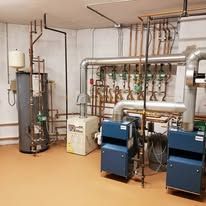 A room with a lot of pipes and machinery in it.