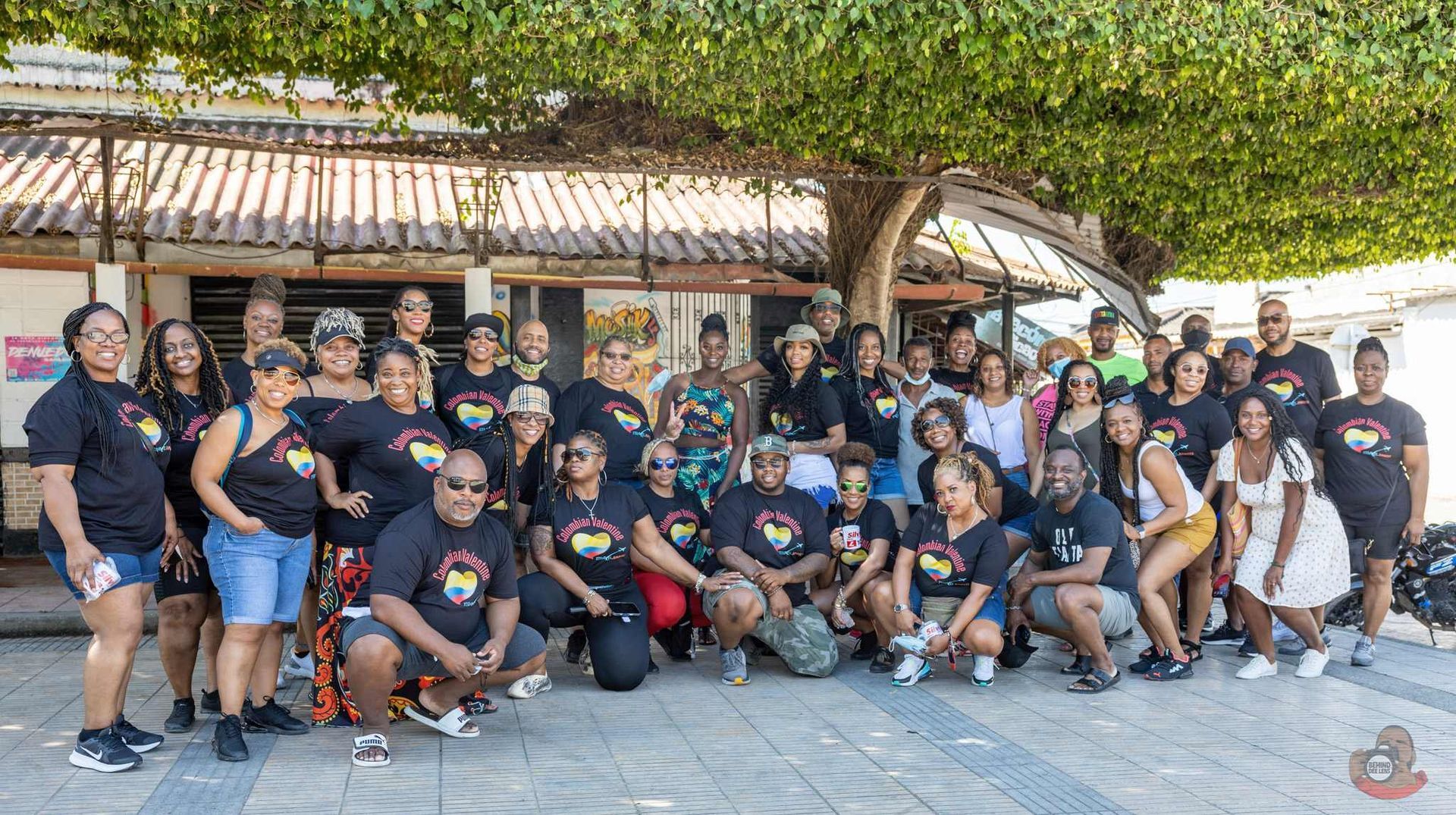 A large group of people are posing for a picture in front of a building.