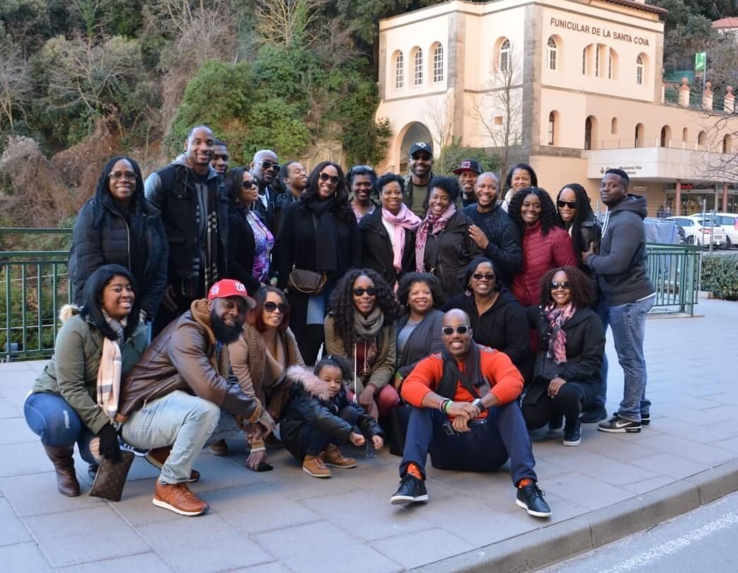 A group of people are posing for a picture in front of a building.