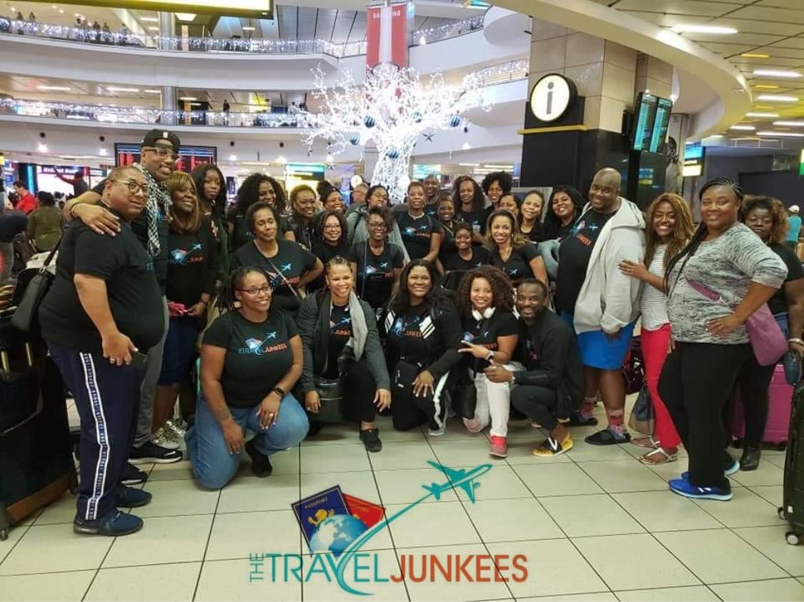 A group of people are posing for a picture in a mall.