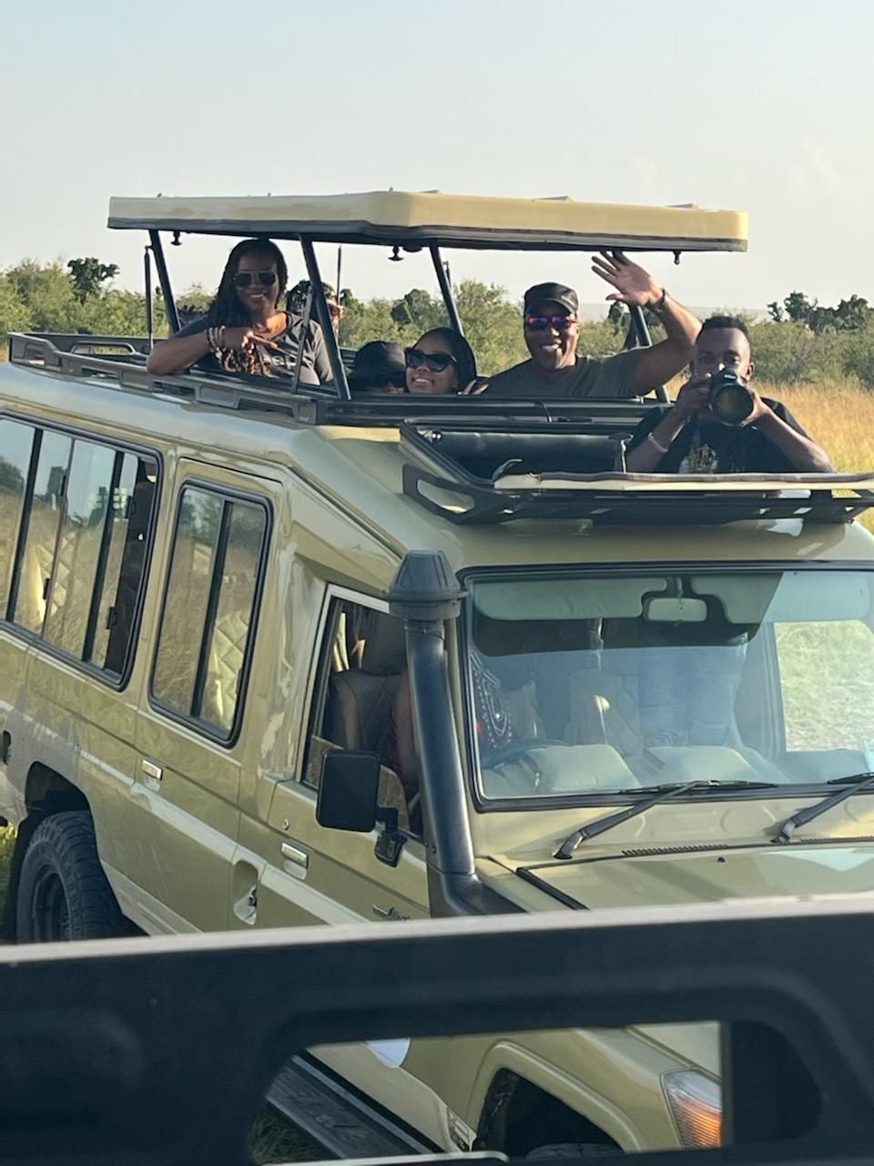 A group of people are riding in the back of a jeep.