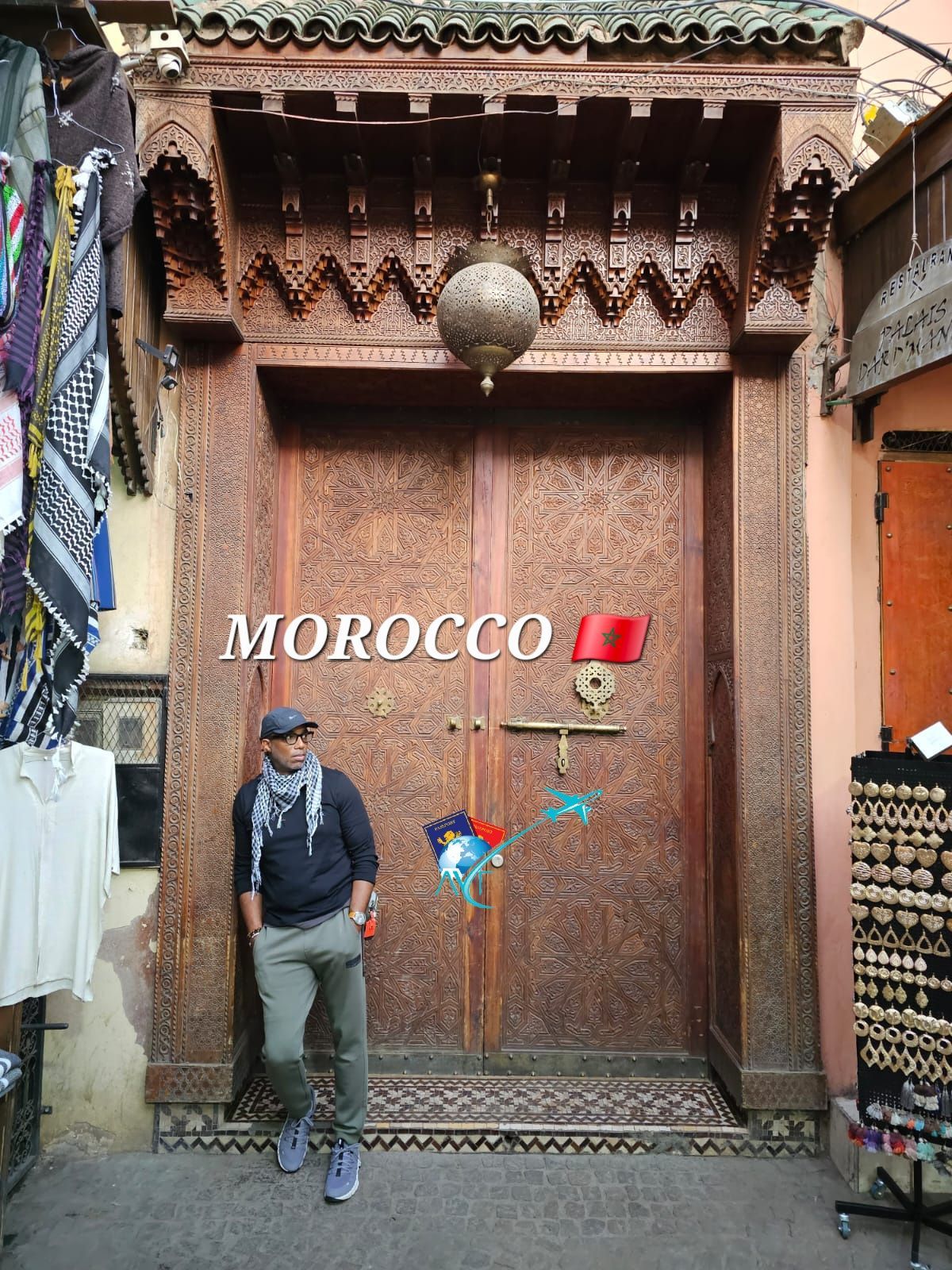 A man is standing in front of a wooden door that says morocco