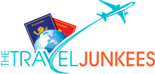 A logo for the travel junkies with a plane flying over a globe and passports