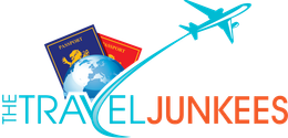 A logo for the travel junkies with a plane flying over a globe and passports