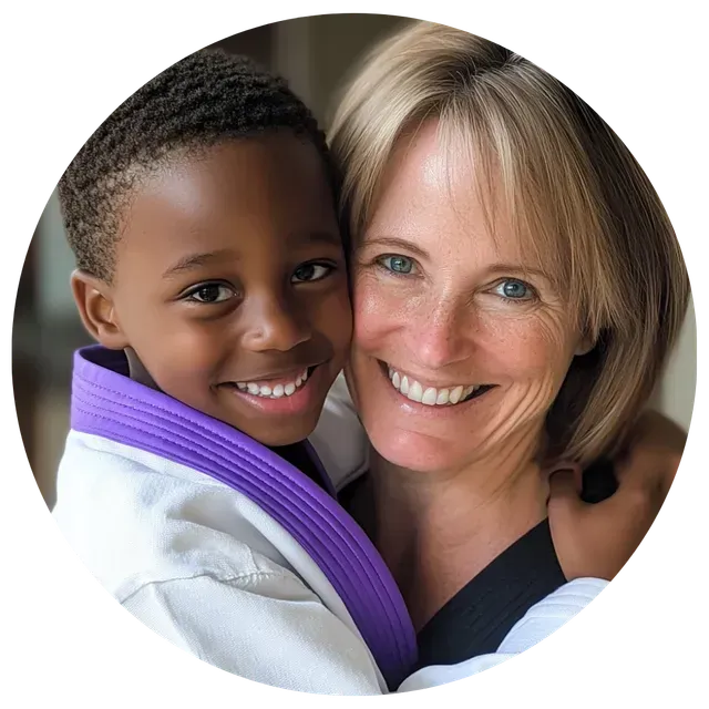 A woman is holding a child who is wearing a purple belt
