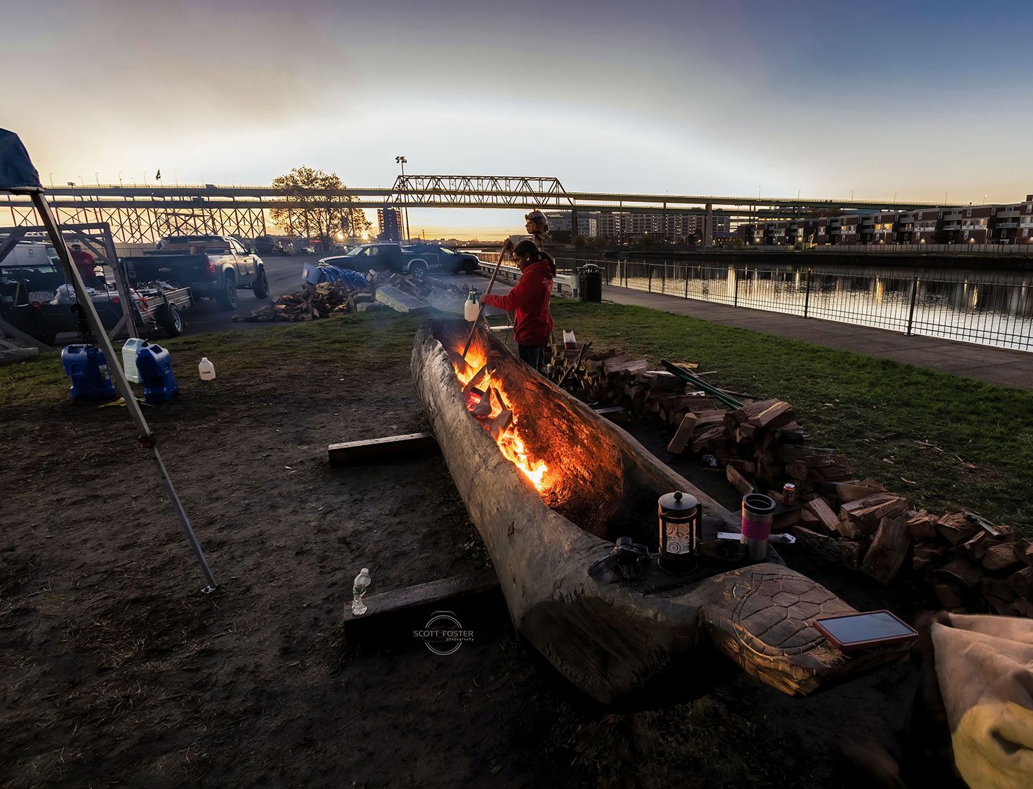 Mishoon canoe burning at sunset in Wesport, MA