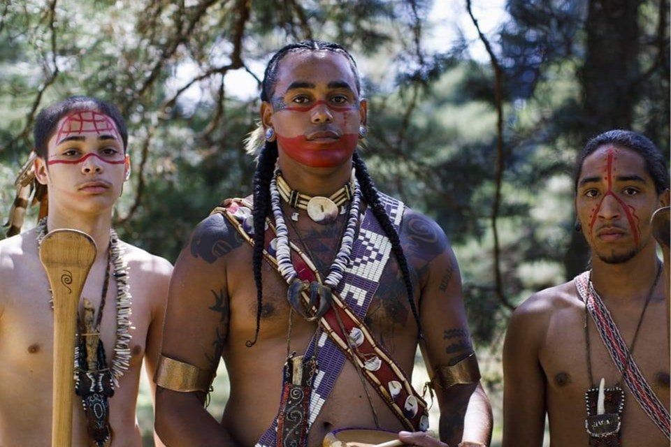 3 indigenous Nipmuc men wearing traditional clothing 