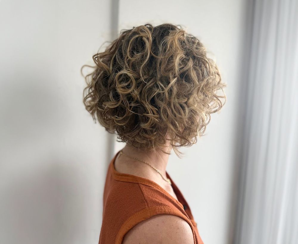 A Young Woman With Her New Curly Haircut