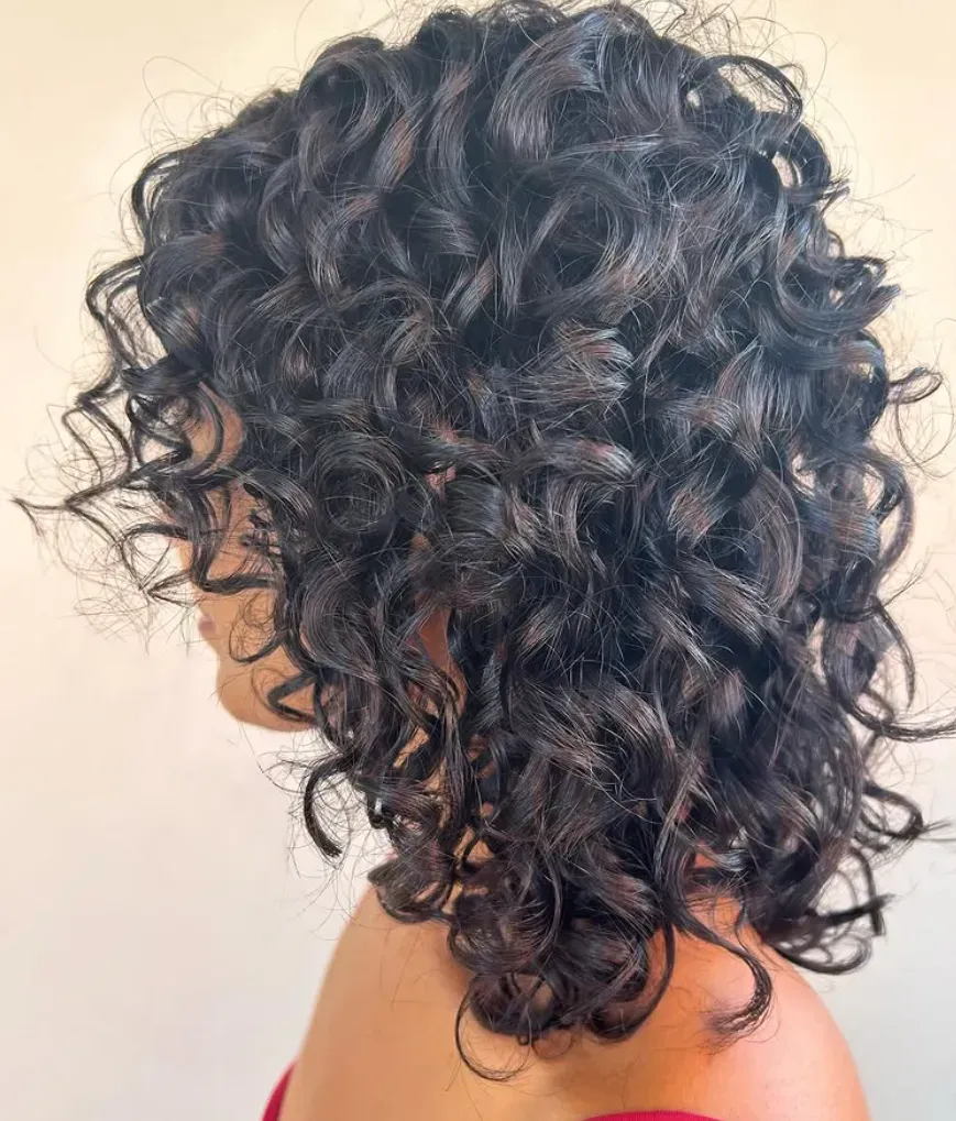 A Young Woman With Her New Curly Haircut