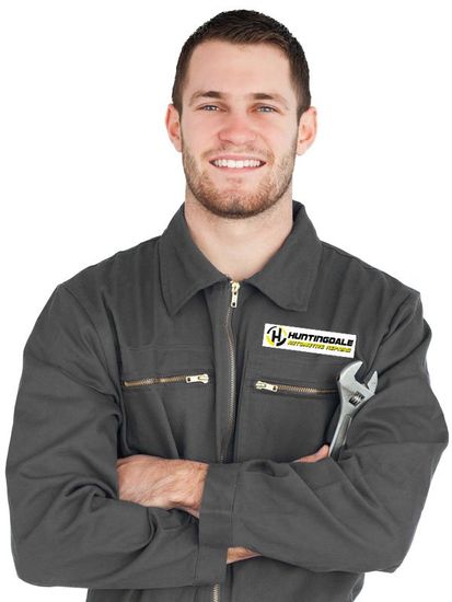 male mechanic with crossed arms and spanner