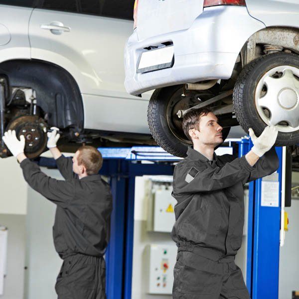 huntingdale automotive repairs mechanics two mechanics working on elevated cars