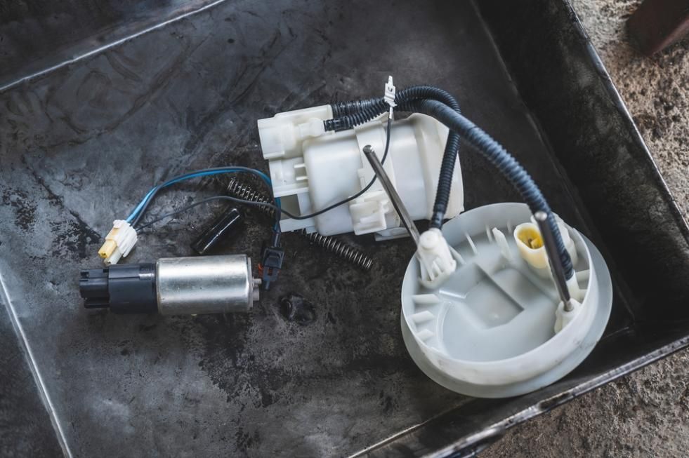 A Fuel Pump Is Sitting On Top Of A Metal Tray — Reef Diesel Injection In Sarina, QLD