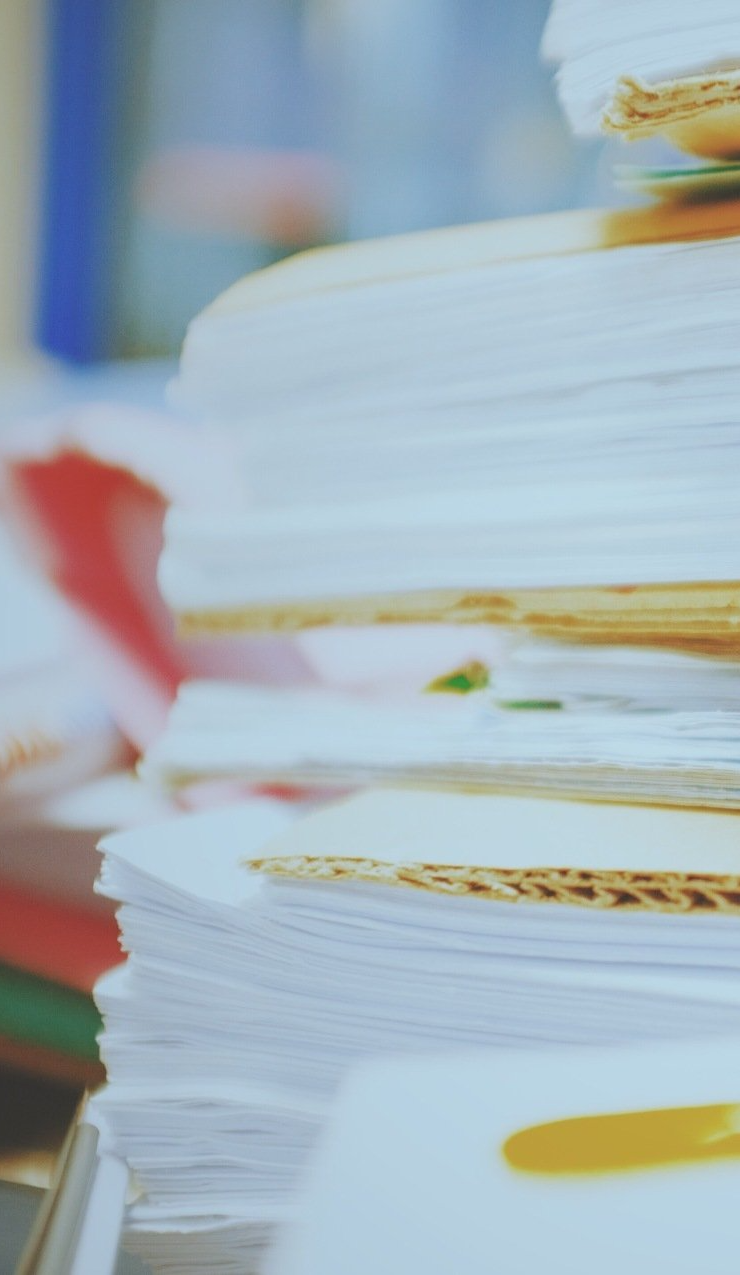 A close up of a stack of papers on a table.