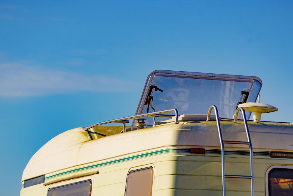 A Cream-coloured Camper With a Blue Sky Background — Total Caravan Repairs in Forster, NSW