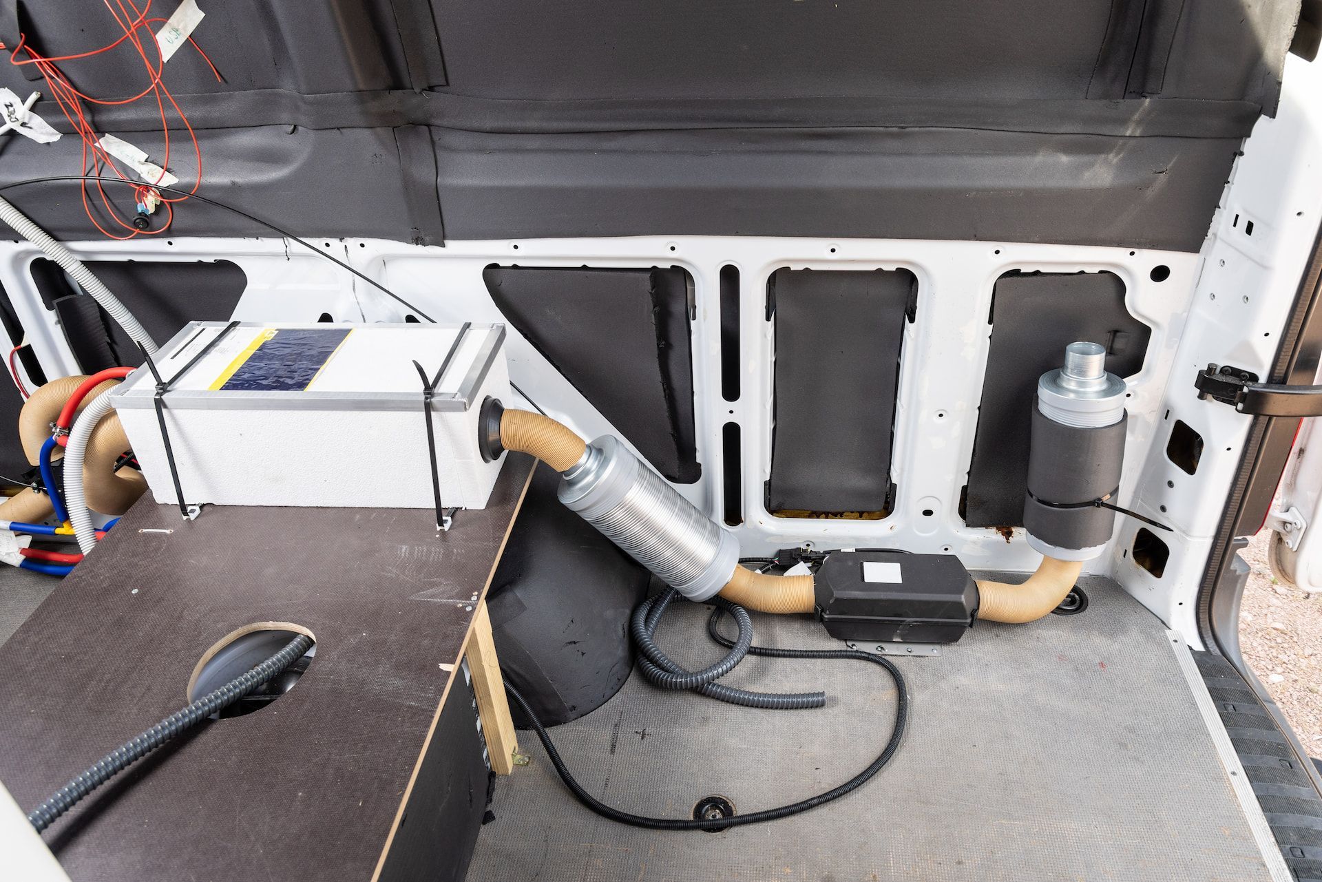 Van Interior With Installed Heater, Battery, and Wiring — Total Caravan Repairs in Nabiac, NSW
