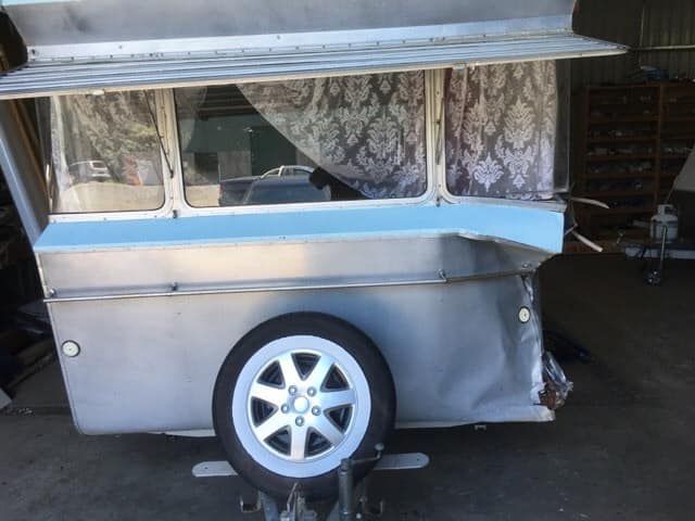 Light Blue and Silver Vintage Caravan With White Spare Tire and Floral Curtains — Total Caravan Repairs in Forster, NSW