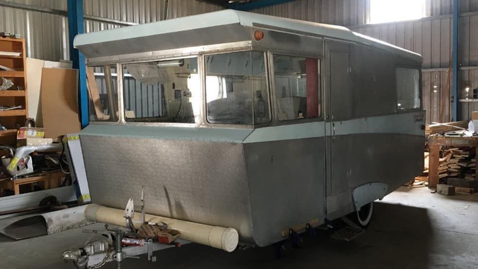 Vintage, Silver and Teal Camper Trailer in a Workshop — Total Caravan Repairs in Taree, NSW