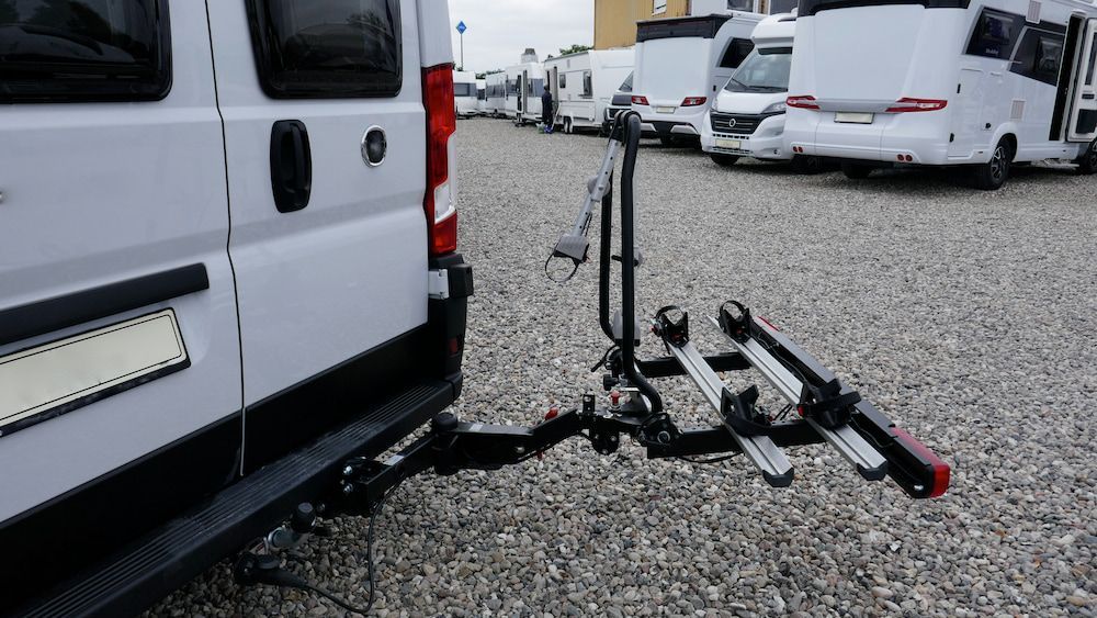 White Van With Bike Rack, Parked in a Lot With Other RVs — Total Caravan Repairs in Forster, NSW