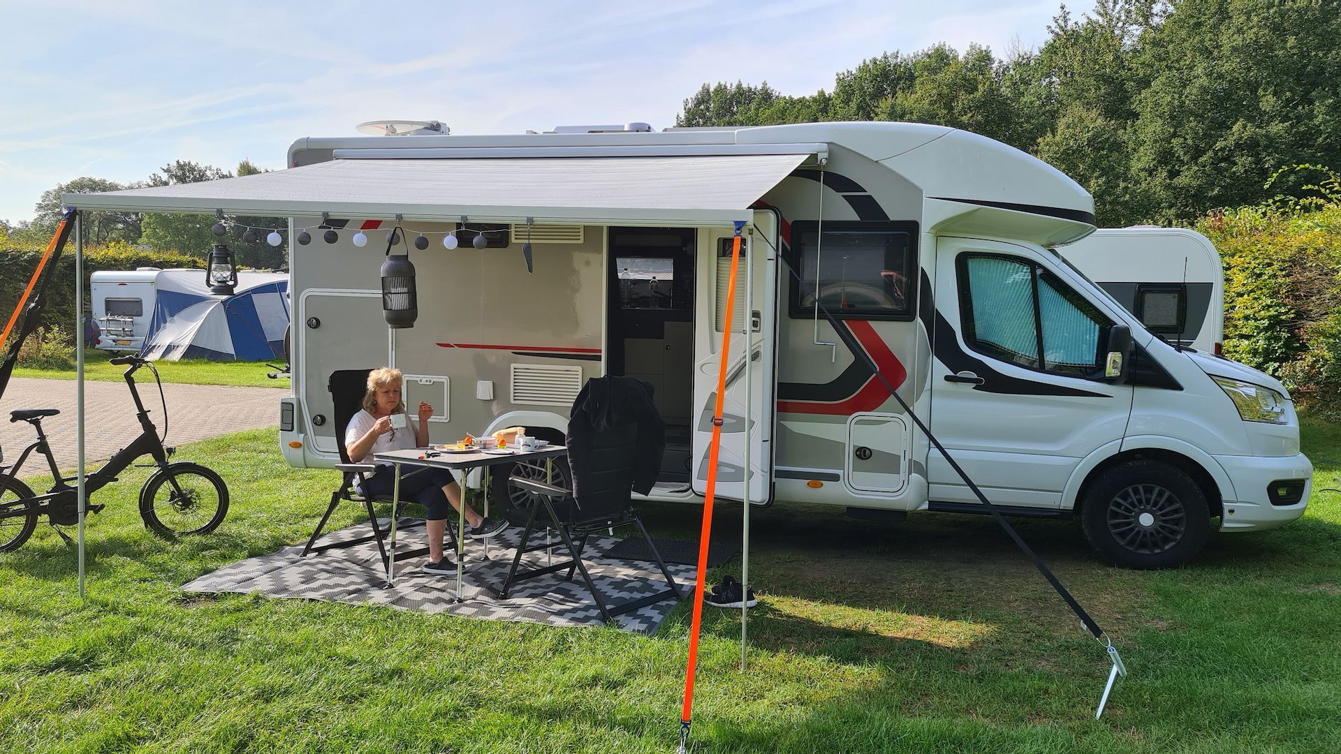 Motorhome Parked on Grass, Awning Extended — Total Caravan Repairs in Nabiac, NSW