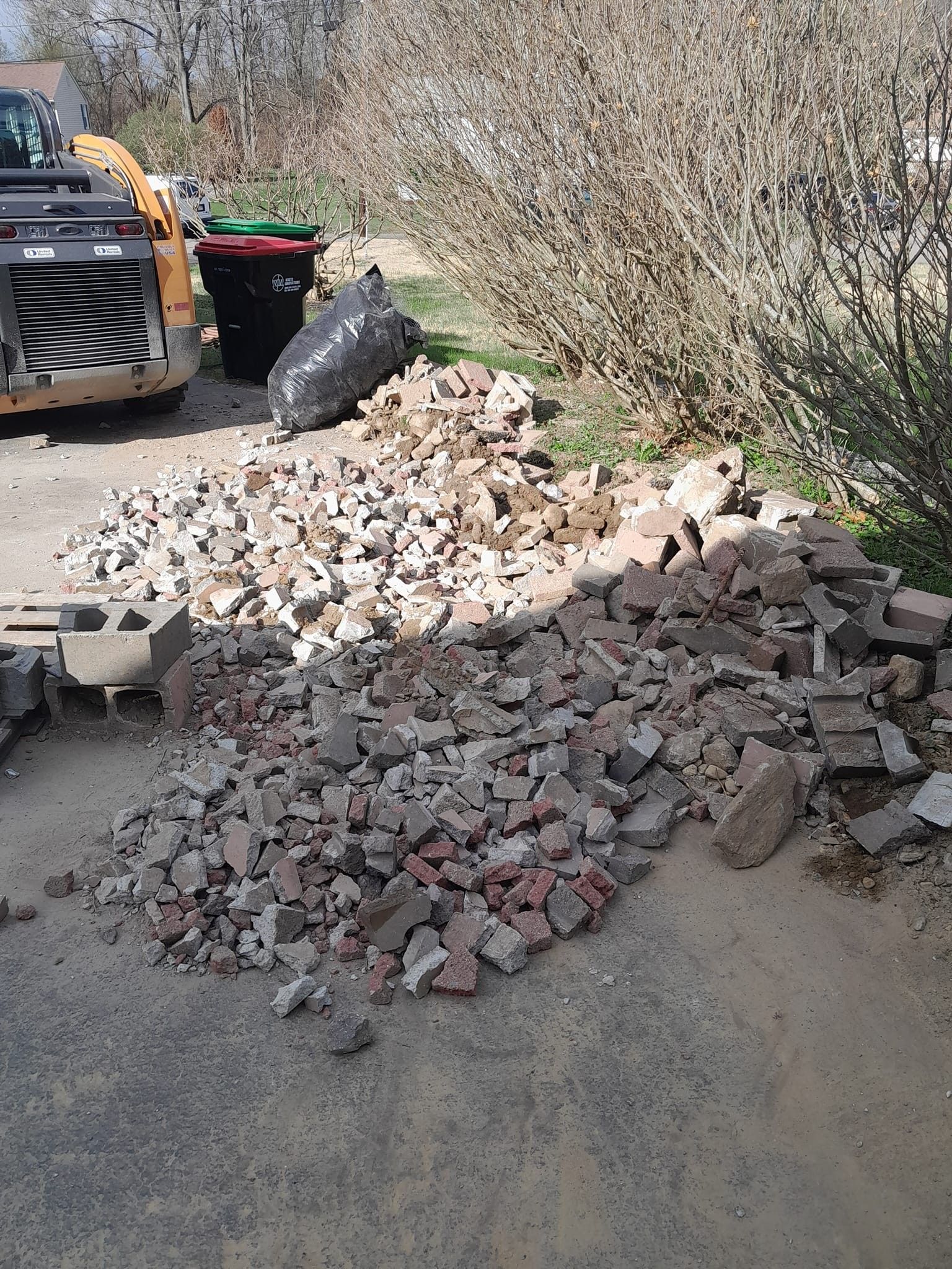 A pile of rocks is sitting on the ground next to a bulldozer.