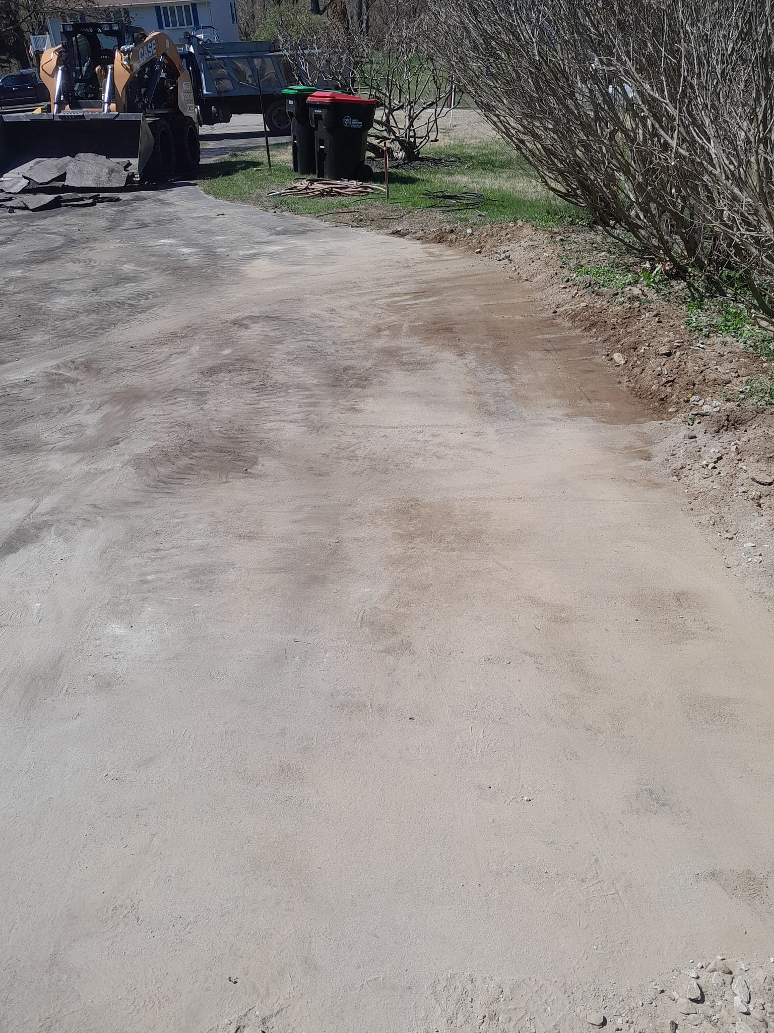 A bulldozer is parked on the side of a dirt road.