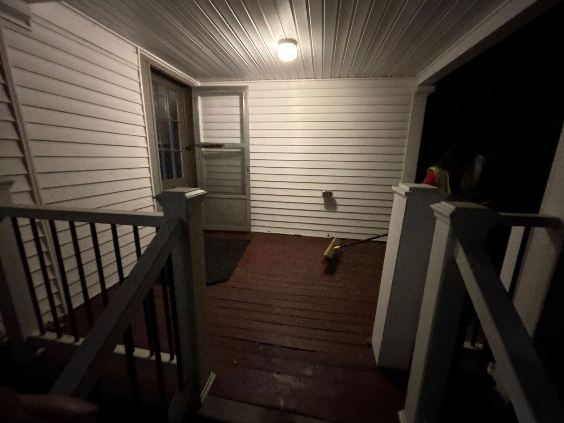 A white house with a porch and stairs