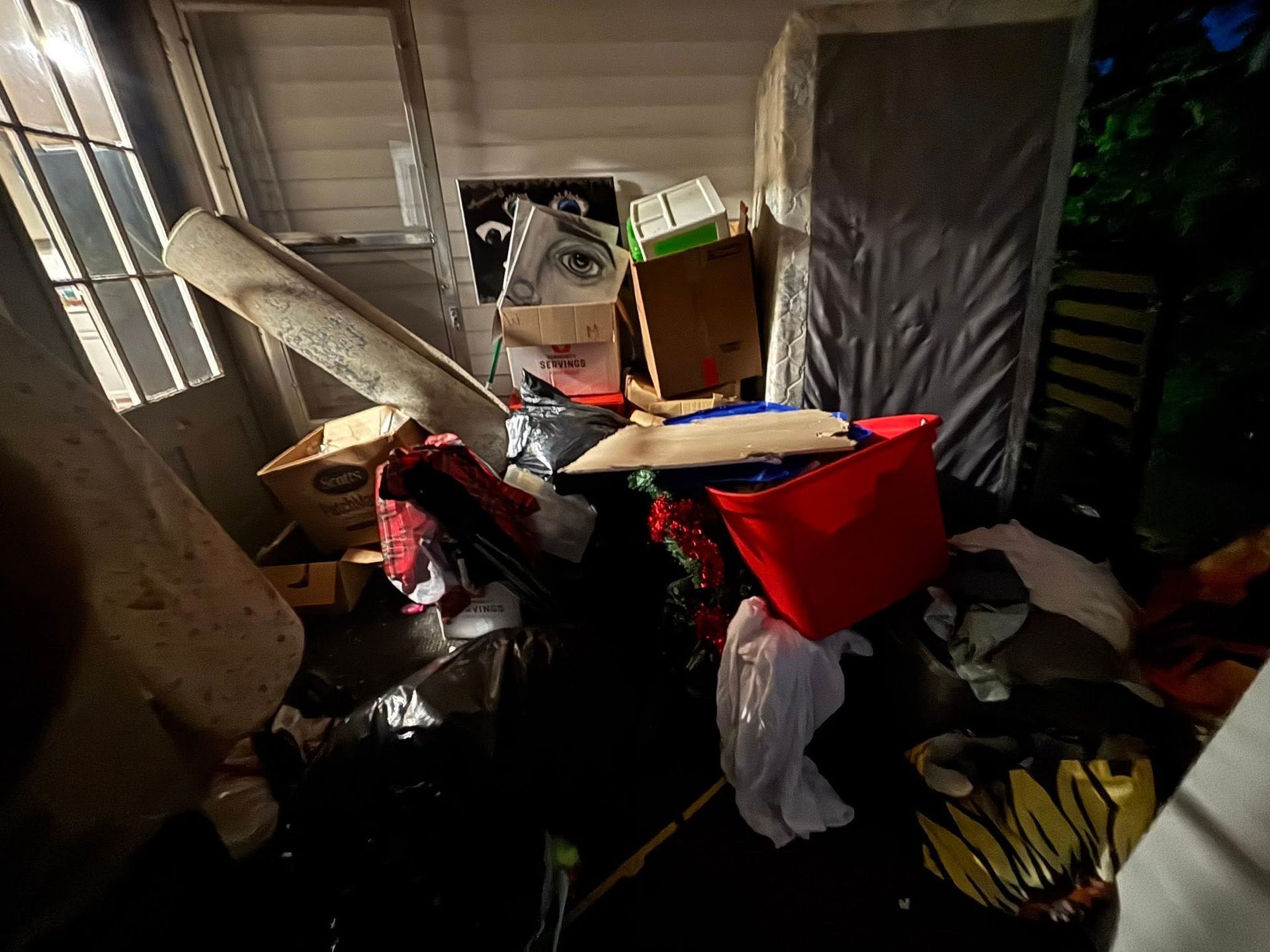 A room filled with lots of junk and boxes.