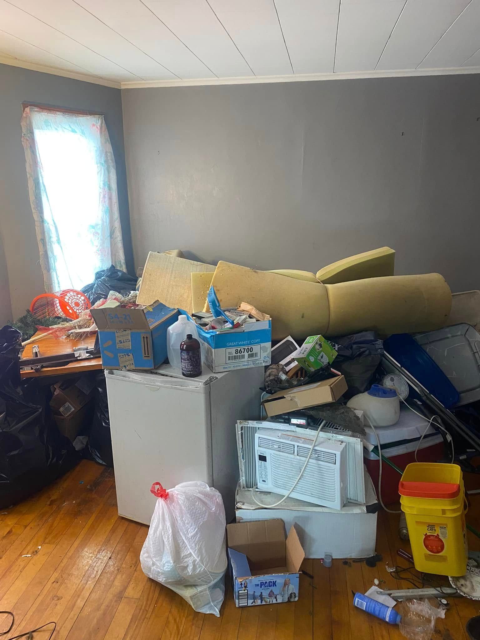 A room filled with lots of junk and a couch.