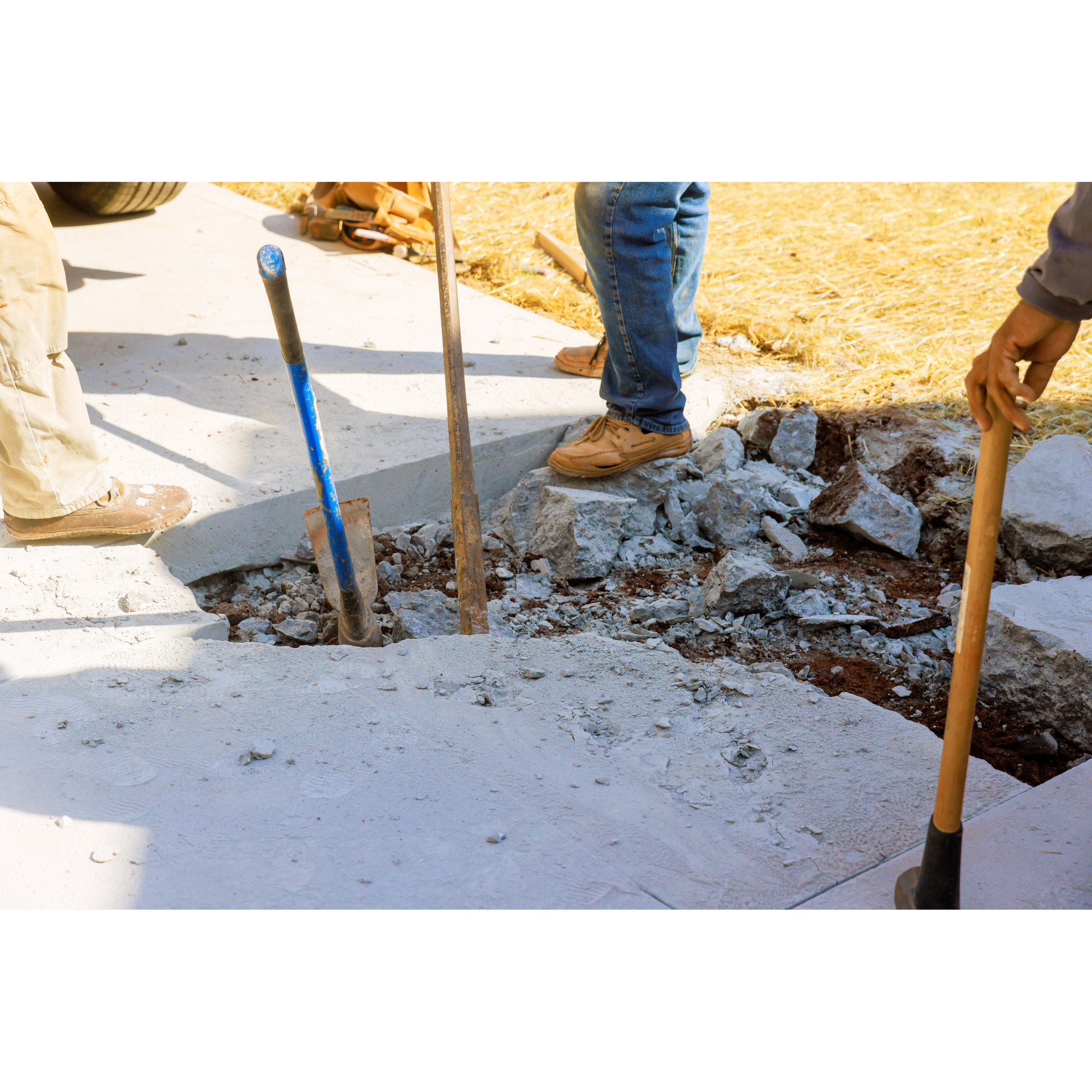 A man is digging a hole in the ground with a shovel.