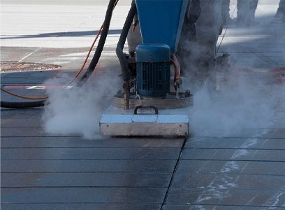 A person is using a machine to clean a concrete floor.