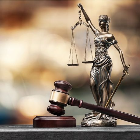 golden lady justice figure next to a gavel