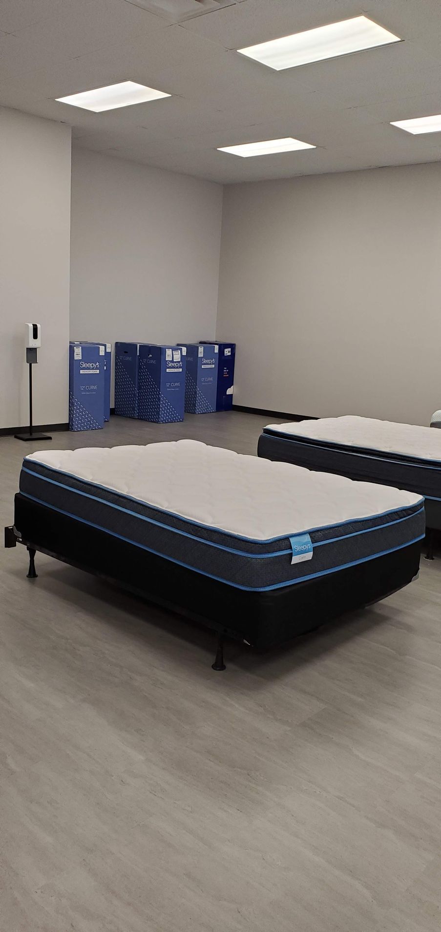 A showroom displaying mattresses. One mattress is in focus.