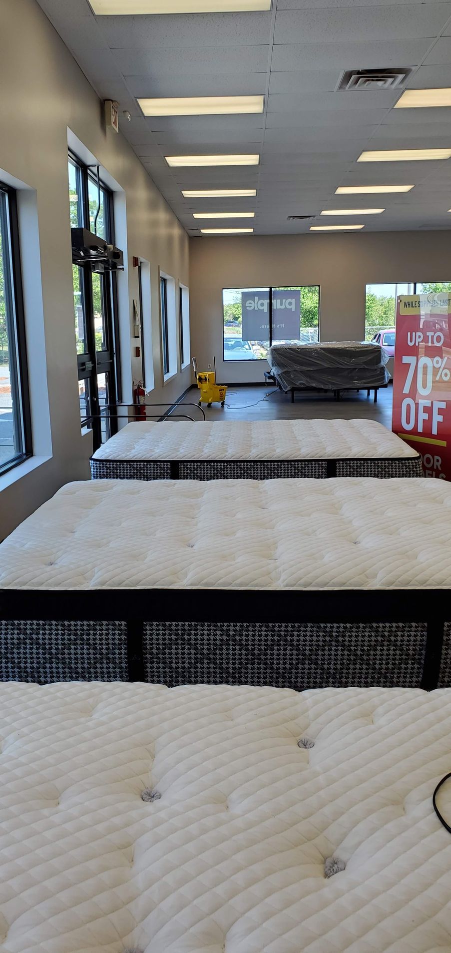 Mattress store interior with displayed mattresses.
