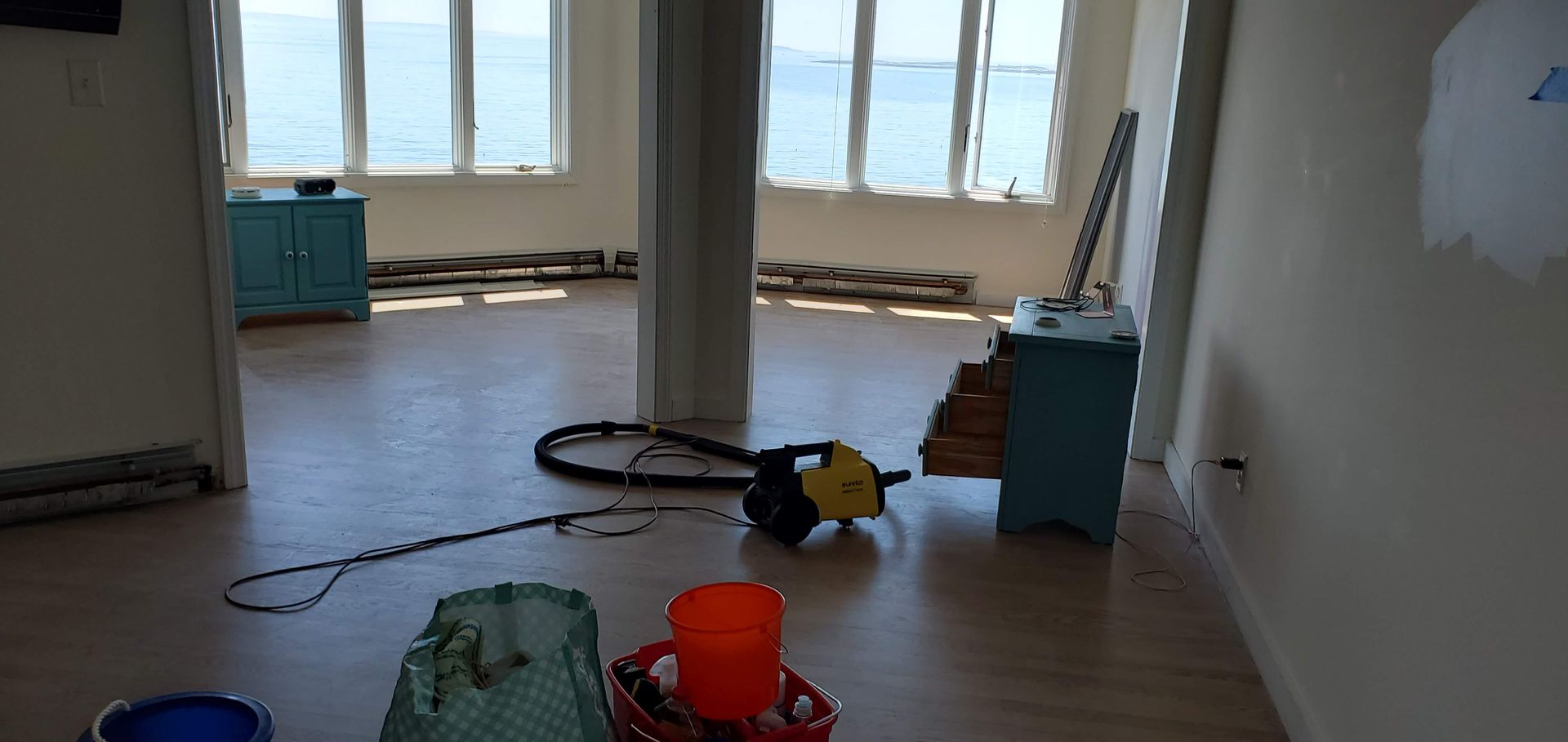 An open room with ocean views and construction materials scattered on the floor.