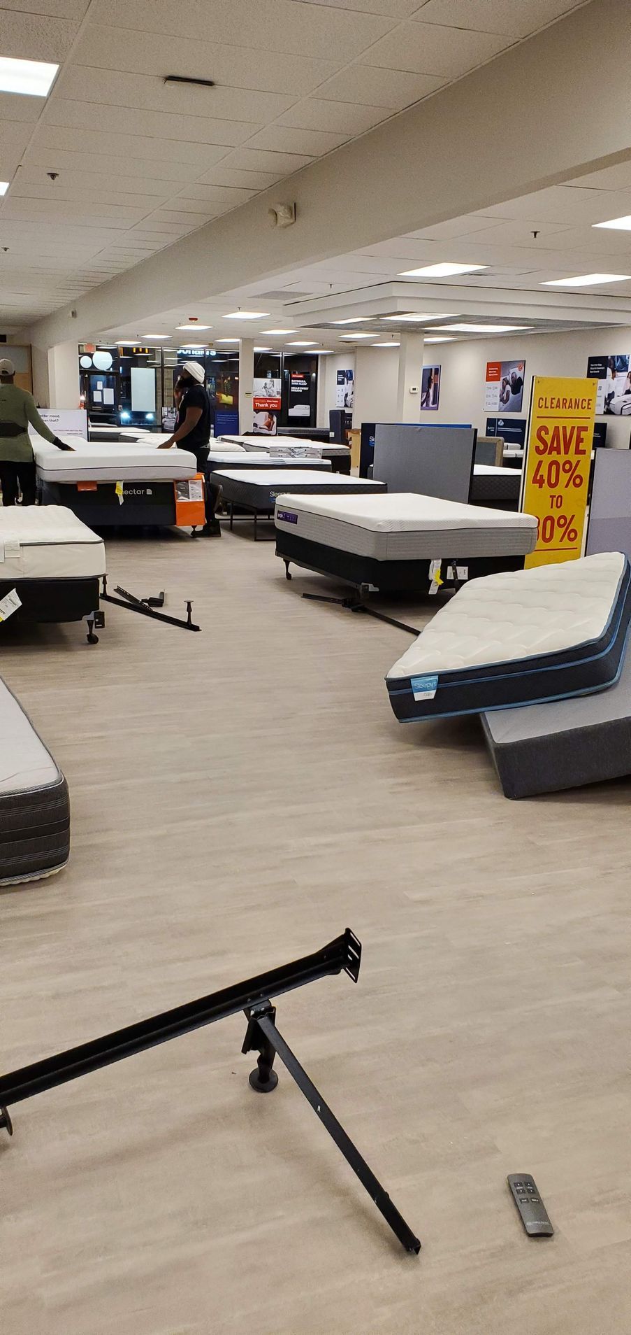 Mattress store interior with various mattresses on display.