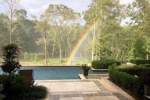 A Lousiana pool with a rainbow in the background.