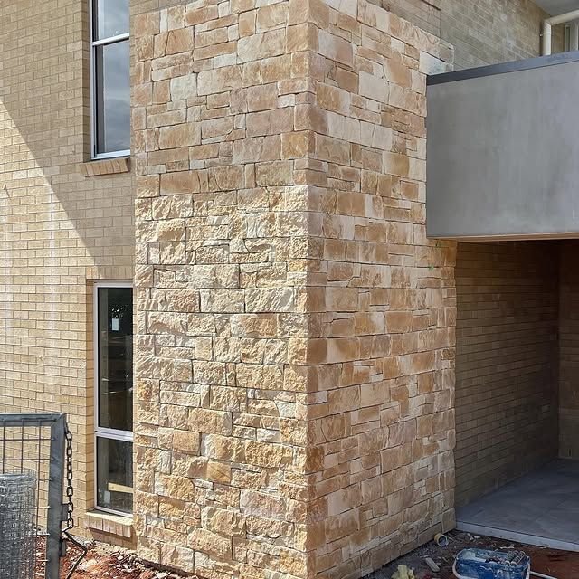 A Brick Building With a Chimney on the Side of It — Accurate Tiling MNC In Dunbogan, NSW
