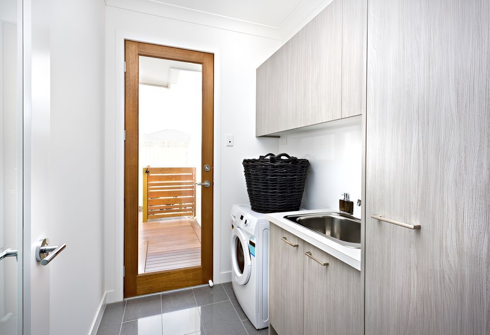 A Laundry Room With a Washer and Dryer and a Sink — Accurate Tiling MNC In Dunbogan, NSW