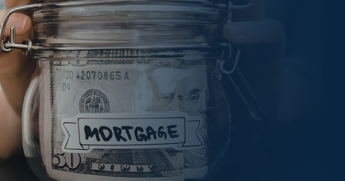 A clear glass jar filled with US fifty-dollar bills, labeled with a white tag that says 