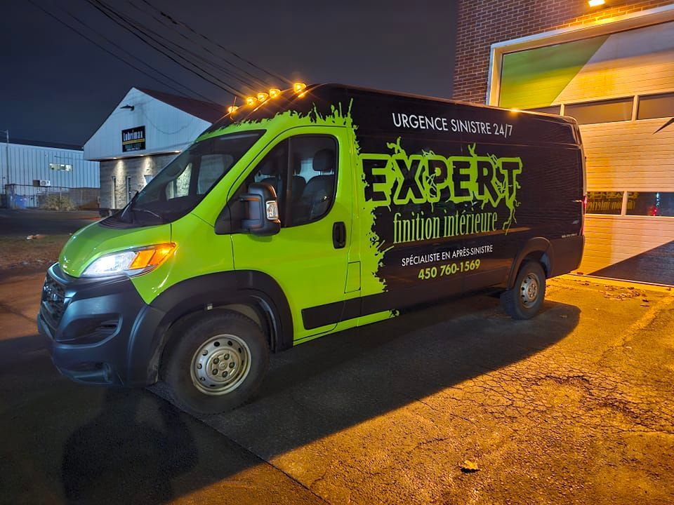 Fourgonnette Expert Frigo Insonorisé verte et noire garée de nuit avec les feux allumés.