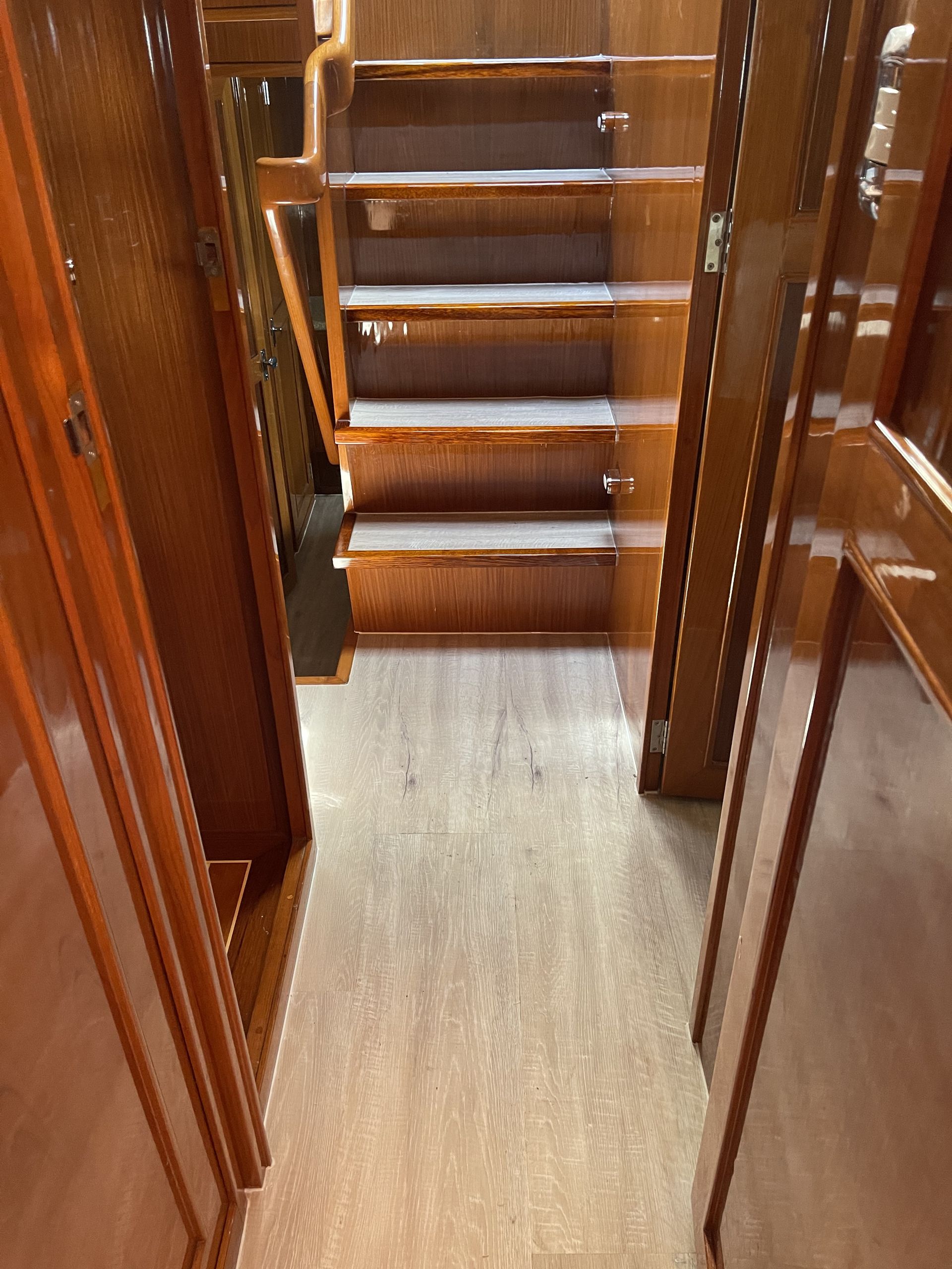 A Room With Wooden Floors and Stacks of Chairs on the Floor — John Chisholm Flooring in Manunda,  QLD